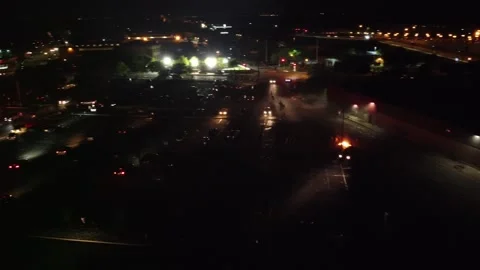 Drone turning and moving forward at low altitude over scary site of civil unrest Stock Footage 134506013