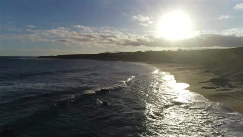 Drone Turns Over Rolling Waves Facing the Late Afternoon Sun at Playa El Stock Footage 342182619