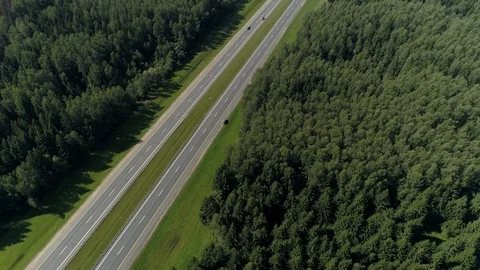 Drone two-way asphalt road out of town country highway interstate Active traffic Stock Footage 117665148
