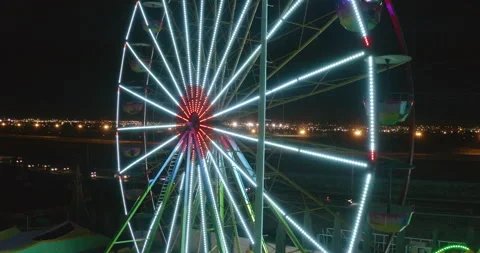 Drone of an unfilled carousel at a carnival with flickering multicolored Vídeos de archivo 232094471