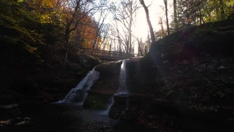 Drone Upwards Scenic Fall Foliage Waterfall Sun Flare Stock Footage 255753802