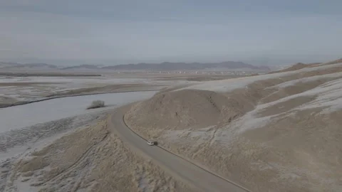 Drone of van driving along winding mountain road in Mongolia Video stock 244324886