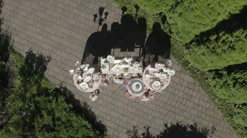 Drone vertically ascending above decorative table installation Stock Footage 330202547