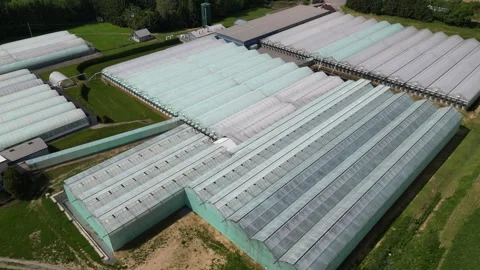 Drone - Very Smooth Fly Away Down to Up of Greenhouses &amp; Farmland, Roads and Stock Footage 314227657
