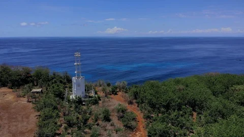 Drone video of an abandoned white lighthouse on the edge of a cliff on the south Stock Footage 127589473