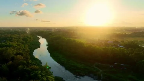 Drone video of bright sunset over winding river Stock Footage 336314980