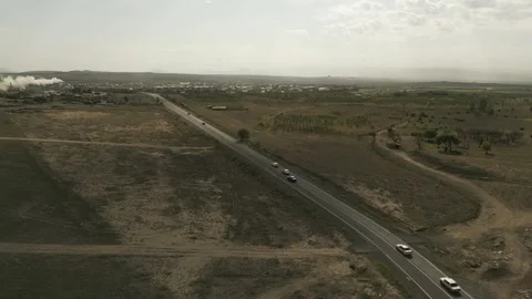 Drone video. Busy highway in deserted rocky terrain. Village, factory, mountains Video stock 252003180