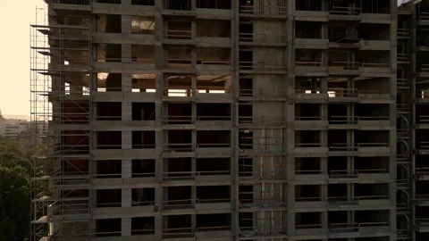 A drone video capturing the construction site of a high-rise building at sunset Stock Footage 286845916