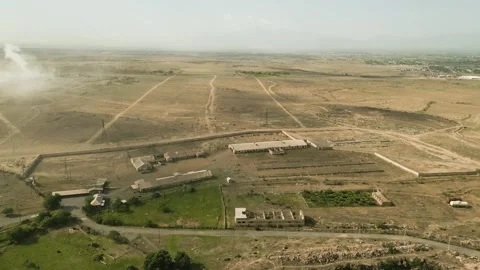 Drone video. A drone flying over industrial buildings in a deserted stony area. Stock Footage 252001071