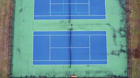 Drone video of an empty blue and green tennis court in a residential area Stock Footage 231045269