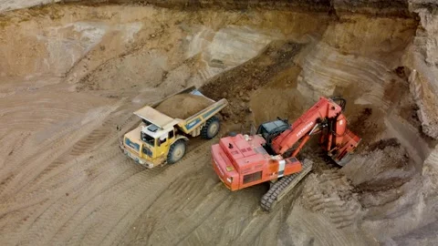 Drone video of excavator loading yellow belaz with sand in quarry. Stock Footage 170387947