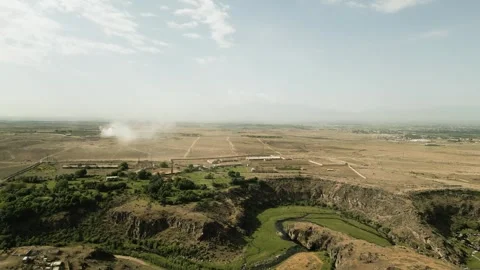 Drone video. Flight over the canyon, river, trees. Buildings, desert, mountains. Stock Footage 252000473