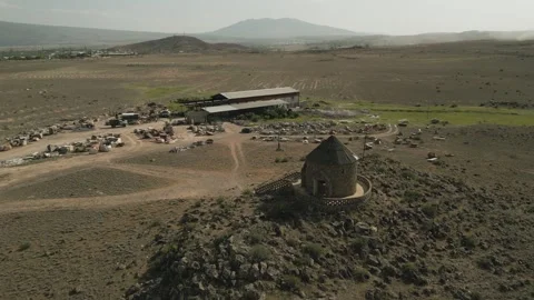 Drone video. Fly around chapel in desert stony terrain with roads, industrial Stock Footage 251986474