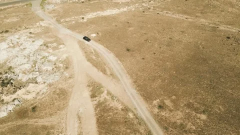 Drone video. Fly over desert rocky terrain, highway, house with garden. Armenia. Stock Footage 251983424
