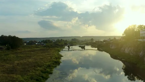 Drone video flying a drone backwards over the mirrored surface of the river duri Video stock 223159093