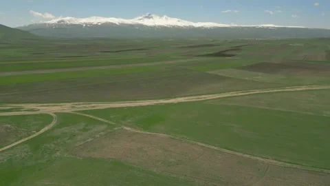 Drone video. Green fields, crossed by country road and power line, Mount Aragats Video stock 252926606
