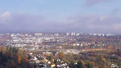 Drone video of highway bridge blasting from side view during daytime in clear Stock Footage 165822589