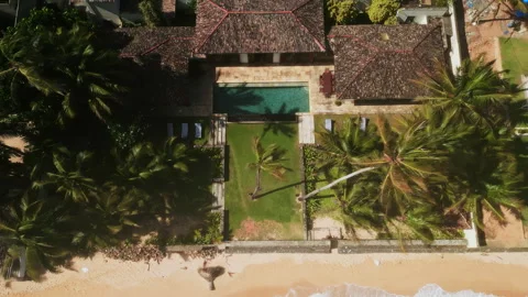 Drone video of large retro villa on tropical island near ocean with sandy beach Stock Footage 252070568