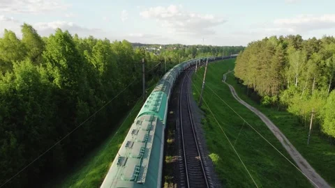 The drone video of a local train, driving through forest and field background. Stock Footage 280792052