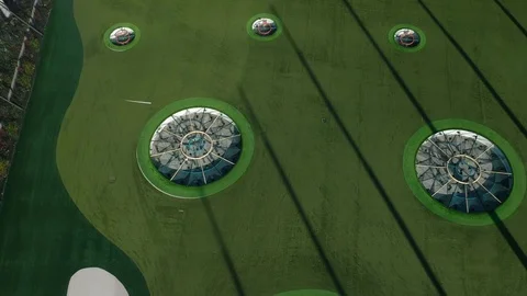 A drone video looking down on a deserted Topgolf tourist attraction due to Stock Footage 127548942