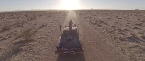 Drone video of Mad Max-inspired Car Driving Thru Desert 動画素材 90724012