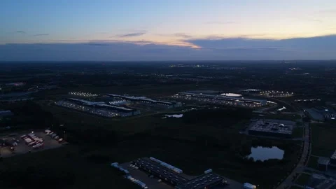 Drone video of Meta massive data center glowing with lights at dusk, showcasing Stock Footage 318287724