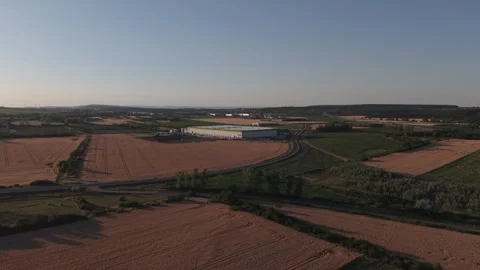 A drone video of a modern warehouse and logistics facility surrounded by Stock Footage 338192114