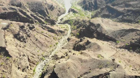 Drone video of a nullah in a valley surrounded by dry mountains Video stock 148666771
