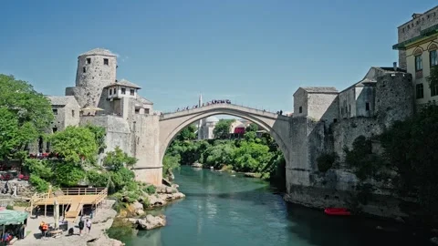 Drone Video of Old Bridge Mostar with Tourists and Boat Crossing Neretva River Stock Footage 316972319
