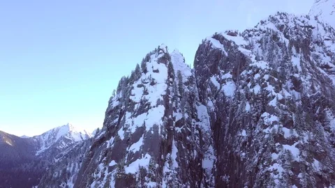 A drone video of orbiting an alpine mountain peak in the winter	 Stock Footage 99288988