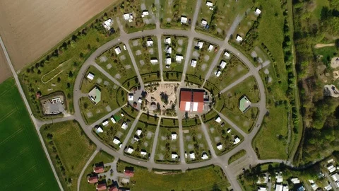 Drone video of oval shape complex of houses among the fields. Aerial view of the Stock Footage 124464713