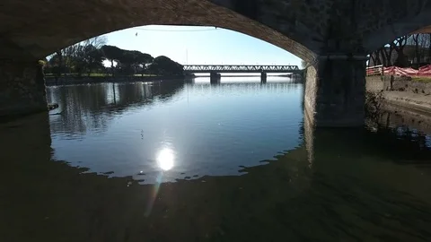 Drone video over river and under a bridge in Italy Stock Footage 76925025