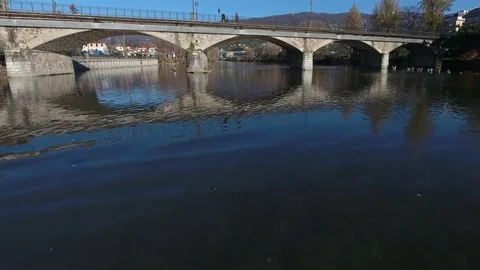 Drone video over river and under a bridge in Italy Stock Footage 76943231