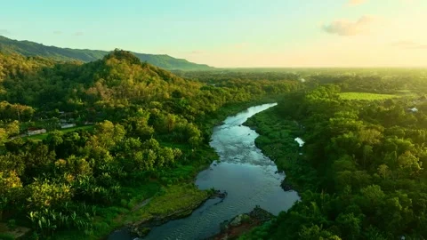 Drone video over winding river and green hills Stock Footage 336314990