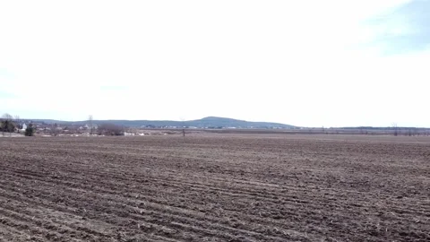 Drone video panning left over an empty agricultural field in spring Stock-Footage 164798473