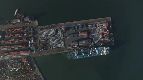 Drone video in a port showing a container cargo ship, containers on the quayside Stock Footage 175581892