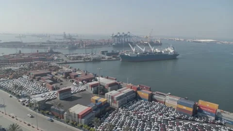 Drone video in a port showing a container cargo ship, containers on the quayside Stock Footage 175590727