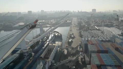 Drone video in a port showing a container cargo ship, containers on the quayside Stock Footage 175649174
