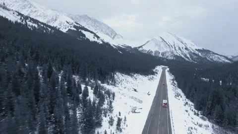 Drone video of road going through mountains and trees in Alberta Stock Footage 143235106