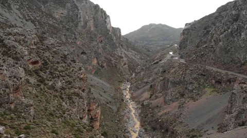 Drone video of a road through a gorge in Greece with mountains and rocks Stock Footage 128191005
