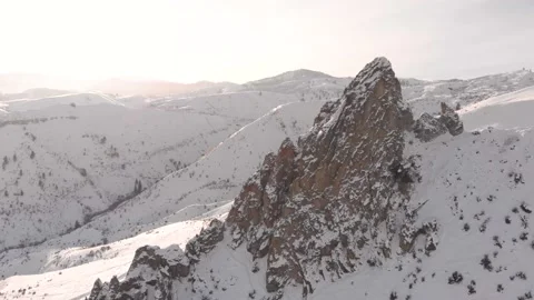 Drone video of rocky pinnacle in snow, 4K Stock Footage 168911075