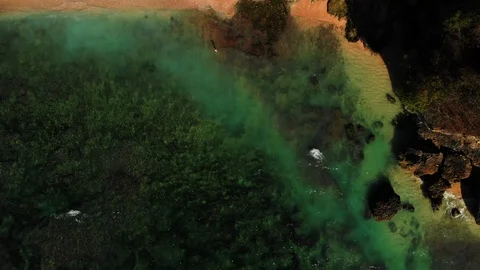 Drone video still image from clear blue sea with beach, rocks and cliff Stock Footage 113784431