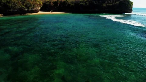 Drone video still image from clear blue water with surfer paddling Stock Footage 113784614