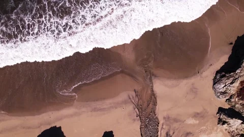 Drone video of the surf flowing onto beach, Big Sur Video stock 247211015