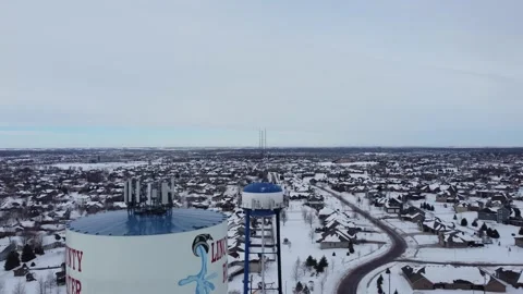 Drone video from the top to base of a water tower with Sioux Falls city in Stock Footage 233609237