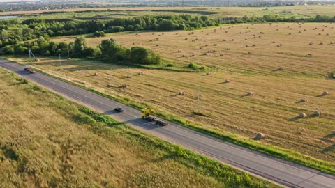 Drone Video - Tracking Shot of A passenger car overtakes a truck on a road Stock Footage 172545836
