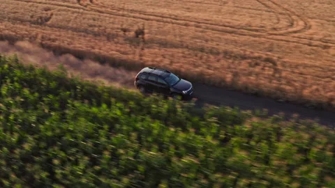 Drone Video - Tracking Shot of SUV driving on a dusty countryside road Stock Footage 172544883