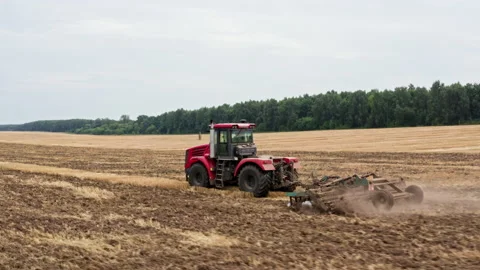 Drone Video - Tracking Shot Of Tractor plows the field for sowing Stock Footage 172503736