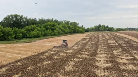 Drone Video - Tracking Shot Of Tractor plows the field for sowing Stock Footage 172503757