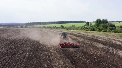 Drone Video - Tracking Shot Of Tractor plows the dry field for sowing Stock Footage 172504088